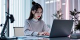 A_young_Korean_woman_sitting_at_a_desk_interactin-1738811172896.jpg